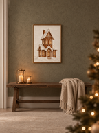 Julposter med snötäckt pepparkakshus ovanför träbänk i varm julinredning